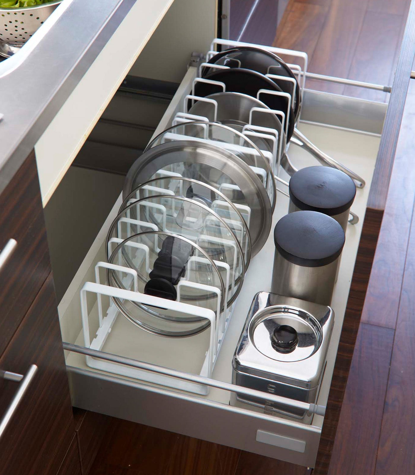 Adjustable organizer rack shown with cookware dividers