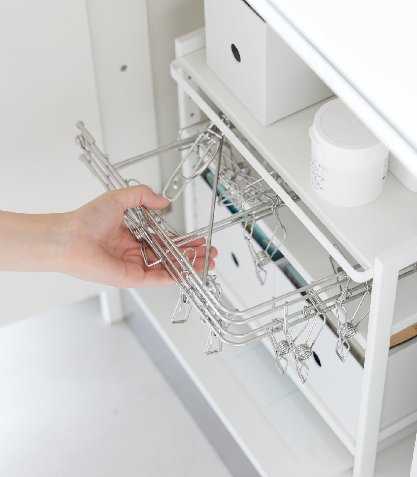 White steel storage rack with tiered shelves